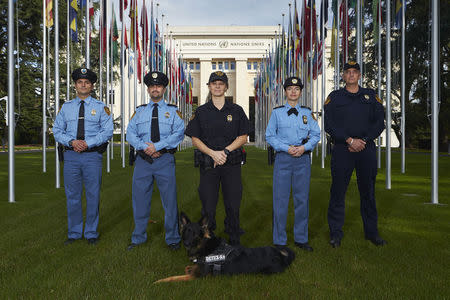 Members of the United Nations security forces pose in front of the U.N. European headquarters in Geneva October 20, 2014. REUTERS/Denis Balibouse