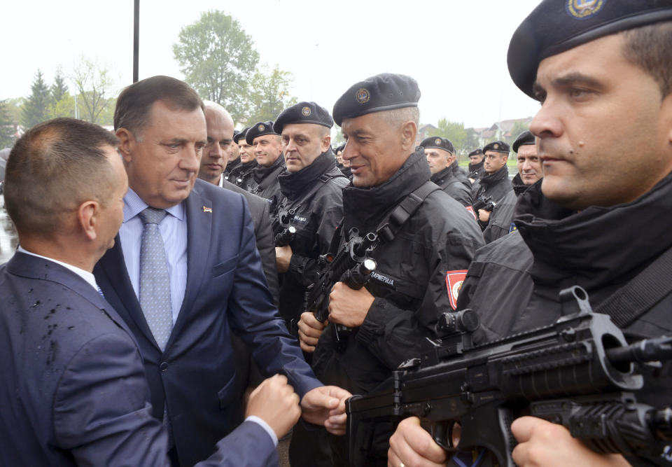FILE- Chairman and Serb member of the tripartite Presidency of Bosnia and Herzegovina Milorad Dodik, second left, inspects ''Gendarmerie'', the new special police unit during the ceremony in Banja Luka, Bosnia, on Sept. 24, 2019. Long-reigning Bosnian Serb leader, Milorad Dodik, has grown increasingly hostile this week as the West turned up the pressure on him to stop a spiraling secessionist campaign in his multiethnic Balkan country of 3.3 million people that has never truly recovered from its fratricidal 1992-95 war. (AP Photo/Radivoje Pavicic, File)