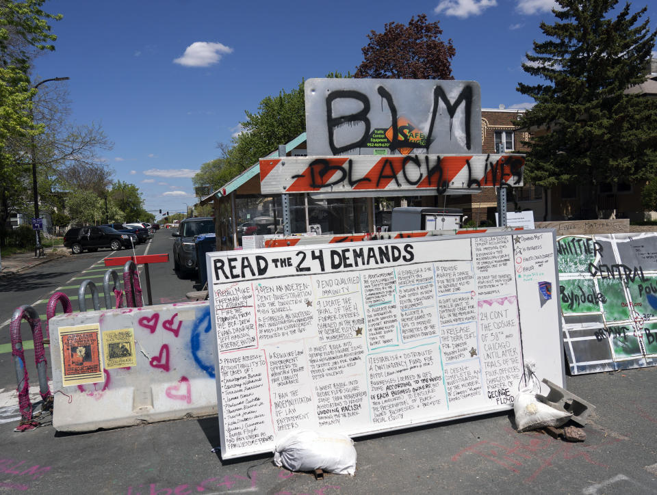 A barricade at one of the entrances to George Floyd Square is marked with a list of demands from the site's caretakers. (Judy Griesedieck for Yahoo News)