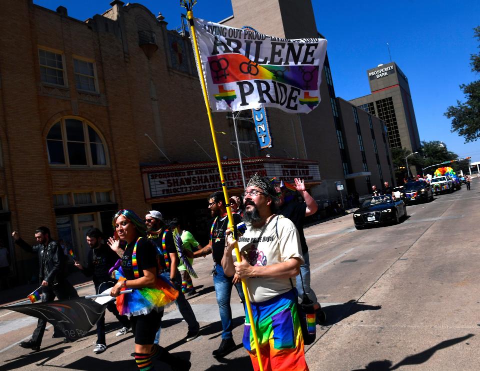 Participants walk past the historic Paramount Theatre during Abilene's first Pride parade Sept. 24.