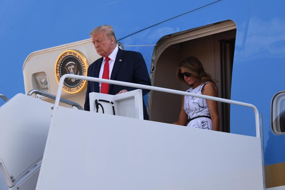 US President Donald Trump and First Lady Melania Trump disembark from Air Force One upon arrival at Ellsworth Air Force Base in South Dakota, July 3, 2020, as they travel to view Independence Day fireworks at Mount Rushmore. (Photo by SAUL LOEB / AFP) (Photo by SAUL LOEB/AFP via Getty Images)