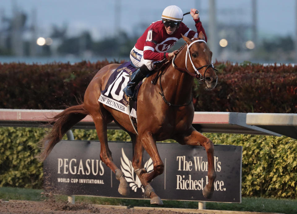 FILE - Jockey Florent Geroux rides Gun Runner (10) past the finish line to win the Pegasus World Cup Invitational horse race, Saturday, Jan. 27, 2018, at Gulfstream Park in Hallandale Beach, Fla. Triple Crown winner Justify, 2017 Horse of the Year Gun Runner and jockey Joel Rosario have been elected to the National Museum of Racing and Hall of Fame in their first year of eligibility. (AP Photo/Lynne Sladky, File)