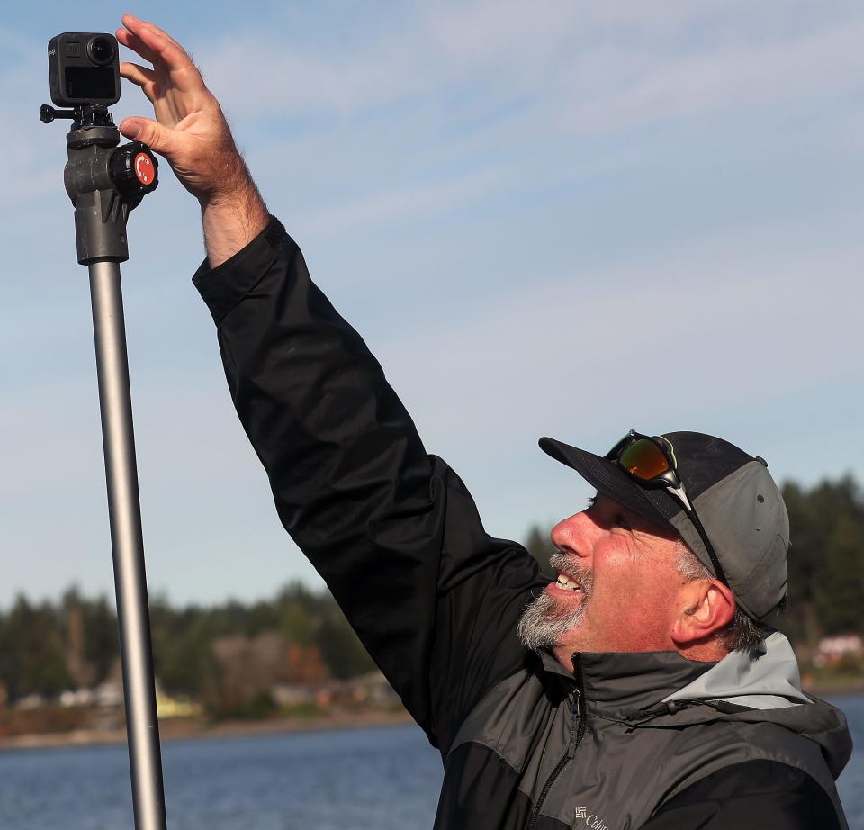 Brian Footen, co-founder and president of EarthViews, adjusts one of the GoPro cameras on his kayak as he prepares to launch at the hops into his kayak at the Tracyton Boat Launch on Wednesday Nov. 17, 2021. 