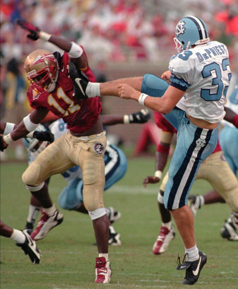 Florida State's Dexter Jackson (11) blocks a punt by North Carolina's Derrick DePriest (33) during the first quarter of play as FSU met North Carolina Saturday, Sept. 28, 1996, in Tallahassee, Fla. (AP Photo/Alan Byrd)