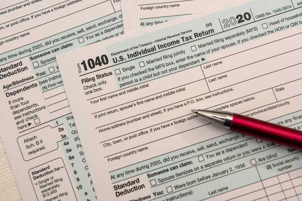 close up of empty us tax form 1040 and ballpoint pen, accounting concept