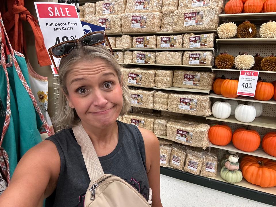 The author looking surprised and a little sad in the aisle of fall decor at Hobby Lobby