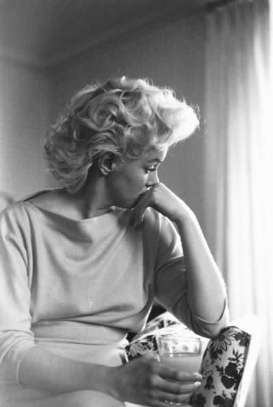 <p>Marilyn appeared introspective in this candid shot in her New York hotel room. </p>