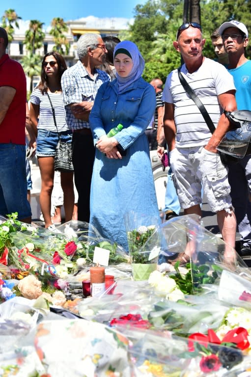 A woman looks on at a make-shift memorial site on July 15, 2016 in Nice, created in tribute to victims of the deadly Bastille Day attack