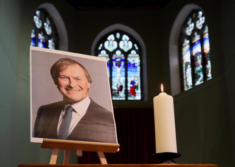 A candle and a portrait of British MP David Amess, who was stabbed to death during a meeting with constituents, are seen at the church of St Michael's and all Angels, in Leigh-on-Sea, Britain, October 17, 2021. / Credit: CHRIS RADBURN / REUTERS