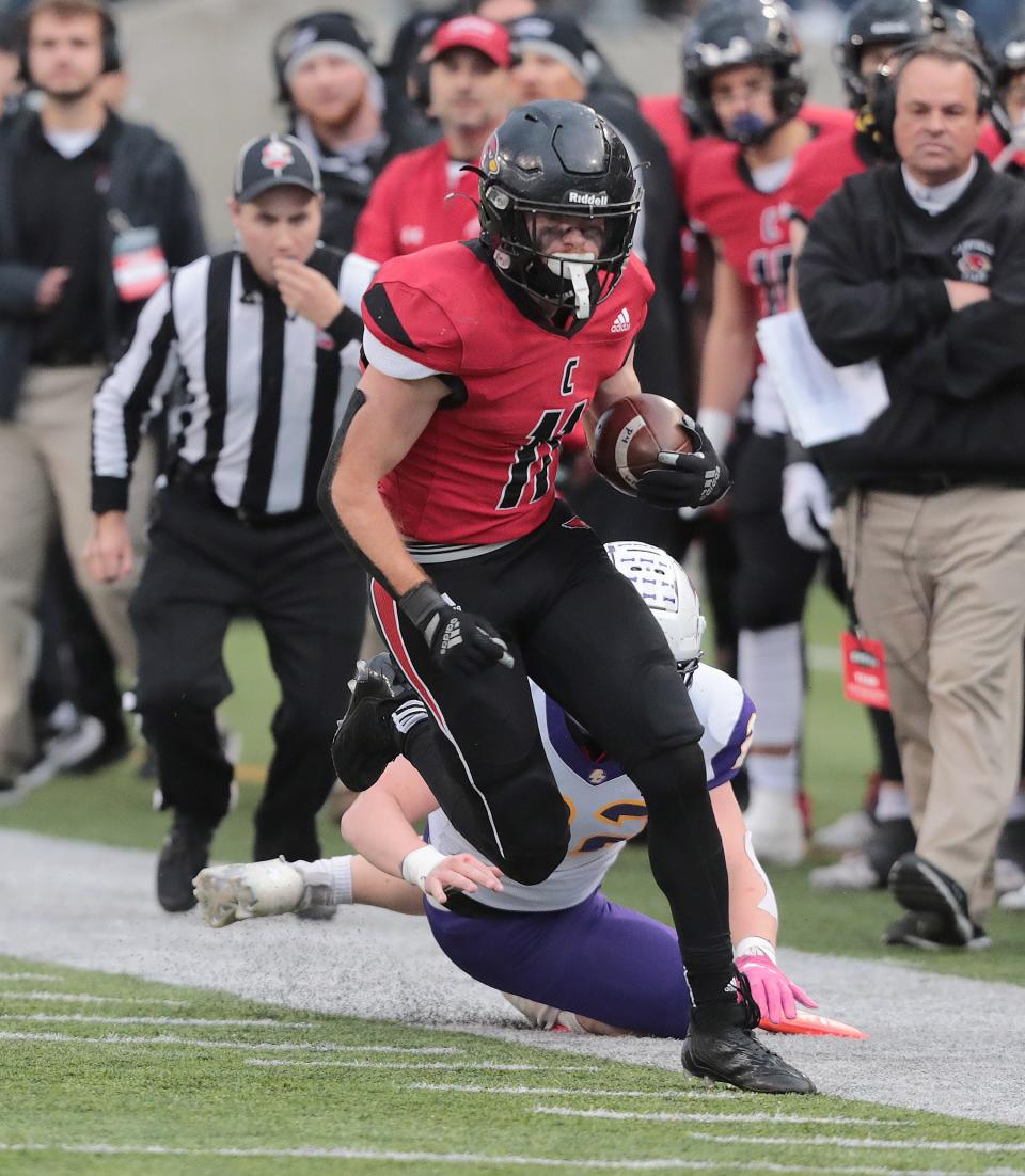 Canfield's Danny Inglis eludes the tackle of Bloom-Carroll's Collin Willet in the first half  during the Division III state final at Tom Benson Hall of Fame Stadium in Canton, Friday, Dec. 2, 2022.