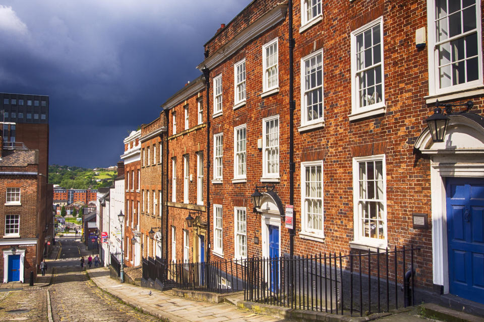 house prices Old red brick Victorian terraces in Sheffield city centre with storm clouds in the back ground.