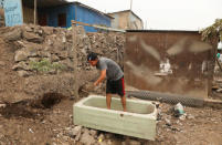 A boy cleans a piece of land in Nueva Union shantytown in Villa Maria del Triunfo district of Lima, Peru, April 29, 2018. REUTERS/Mariana Bazo