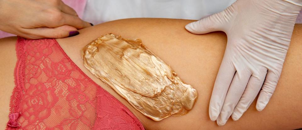 wax on woman's leg next to vagina