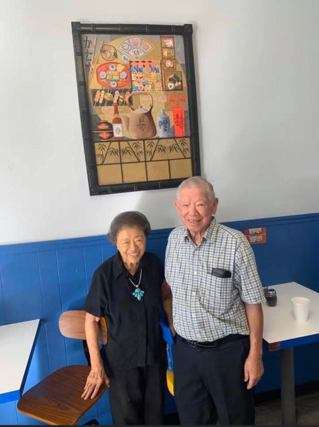 Betsy and Howard Yee, owners of Phoenix Blue Fin pose for a photo inside their restaurant.