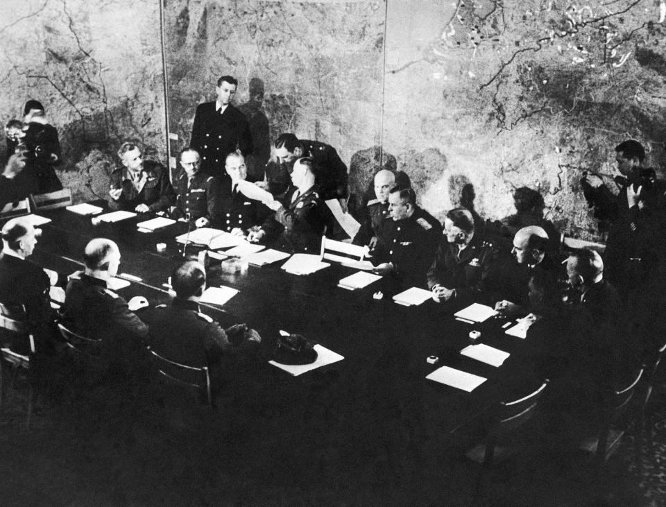 FILE - In this May 7, 1945 file photo representatives of German and Allied nations are present at the Supreme Allied H.Q. War Room in Reims, France, where German delegates surrendered unconditionally. Nazi commanders signed their surrender to Allied forces in a French schoolhouse 75 years ago this week, ending World War II in Europe and the Holocaust. Unlike the mass street celebrations that greeted this momentous news in 1945, surviving veterans are marking V-E Day this year in virus confinement, sharing memories with loved ones, instead of in the company of comrades on public parade. (AP Photo/File)