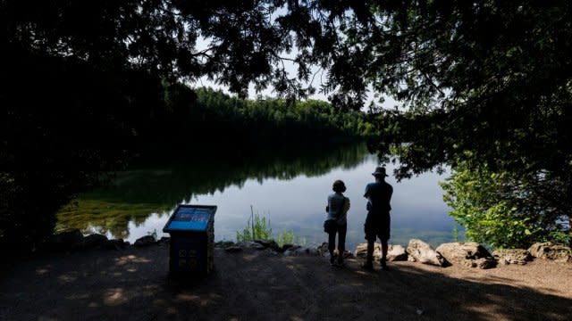 People look at Crawford Lake in Canada