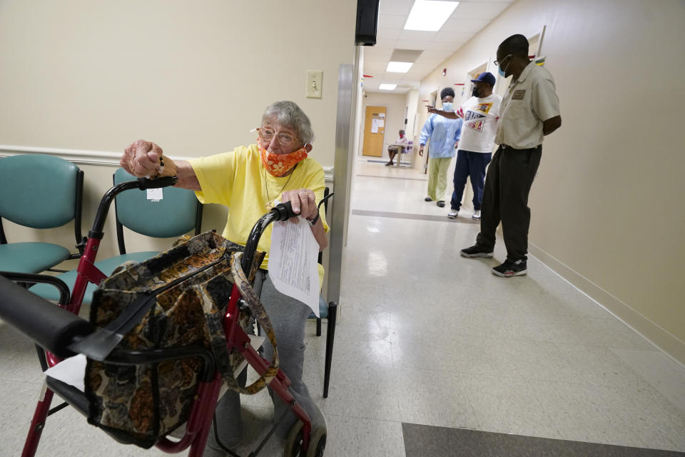 Linda Busby, 74, waits to receive her Johnson & Johnson COVID-19 vaccine at the Aaron E. Henry Community Health Service Center, Wednesday, April 7, 2021, in Clarksdale, Miss. Busby joined a group of seniors from the Rev. S.L.A. Jones Activity Center for the Elderly that were given a ride to the health center for their vaccinations. The Mississippi Department of Human Services is in the initial stages of teaming up with community senior services statewide to help older residents get vaccinated. (AP Photo/Rogelio V. Solis)