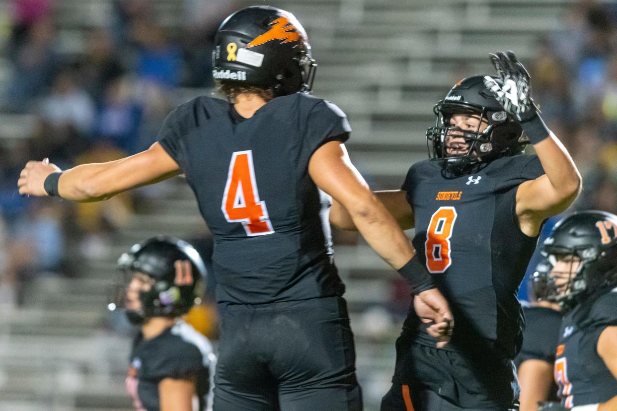 Apple Valley’s Noah Celie, right, celebrates with Dustin Reynolds after scoring a touchdown against Serrano on Sept. 30, 2021, at Newton T. Bass Stadium.