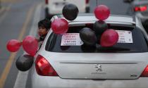 Fans of the Newell's Old Boys soccer club take part in a caravan in the hometown of soccer star Leonel Messi, in Rosario, Argentina, Thursday, Aug. 27, 2020. Fans hope to lure him home following his announcement that he wants to leave Barcelona F.C. after nearly two decades with the Spanish club. (AP Photo/Natacha Pisarenko)