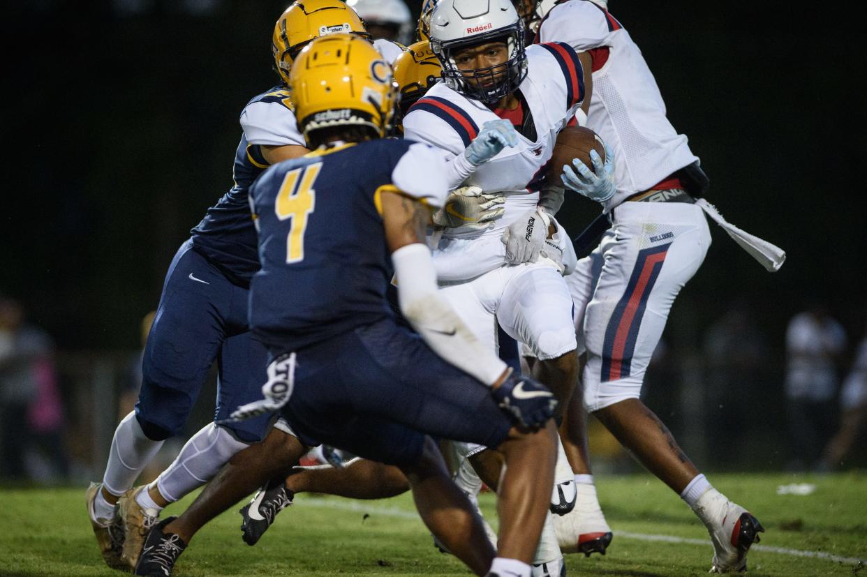 Terry Sanford’s Rashid Jones gets swarmed by Cape Fear defense during the first quarter on Friday, Sept. 1, 2023, at Cape Fear High School.