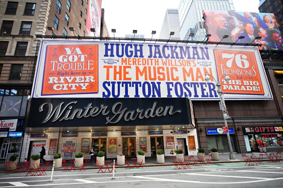 The exterior of Winter Garden theater has a large banner advertising "The Music Man," Hugh Jackman and Sutton Foster.