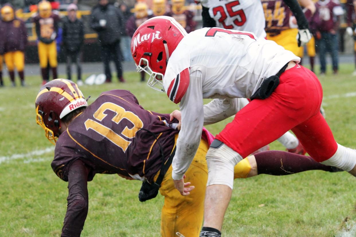 Tucker Lafler tackles Au Gres-Sims quarterback Mason VanSickle during the state semifinals on Saturday.