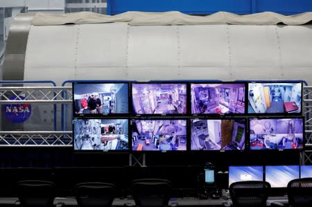 Video screens monitor the inside of a replica International Space Station at Johnson Space Center in Houston, Texas