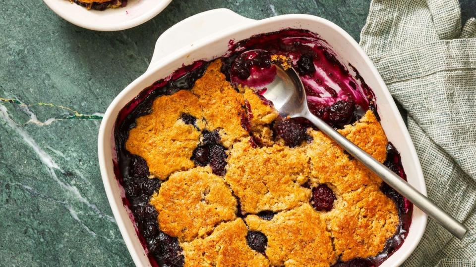 mixed berry cobbler in a white baking dish