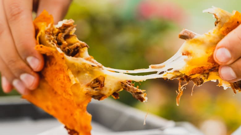 birria, melted cheese being pulled