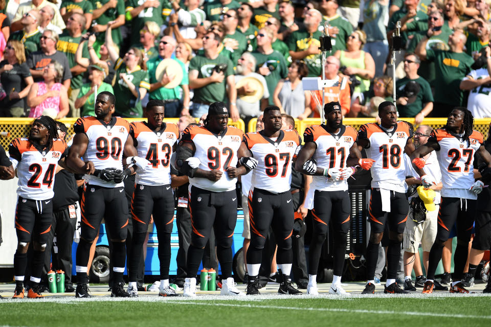 Members of the Cincinnati Bengals stand with arms locked as a sign of unity during the national anthem prior to their game against the Green Bay Packers at Lambeau Field on September 24, 2017. (Photo by Stacy Revere/Getty Images)