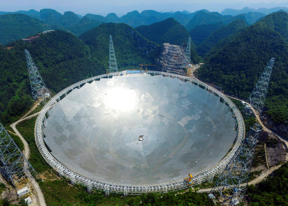A 500-metre (1,640-ft.) aperture spherical telescope (FAST) is seen at the final stage of construction, among the mountains in Pingtang county, Guizhou province, China, May 7, 2016.   REUTERS/Stringer  ATTENTION EDITORS - THIS IMAGE WAS PROVIDED BY A THIRD PARTY. EDITORIAL USE ONLY. CHINA OUT. NO COMMERCIAL OR EDITORIAL SALES IN CHINA.      TPX IMAGES OF THE DAY     