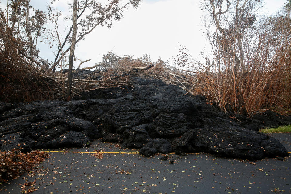 <p>A lava flow blocks a road on the outskirts of Pahoa during ongoing eruptions of the Kilauea Volcano in Hawaii, June 6, 2018. (Photo: Terray Sylvester/Reuters) </p>