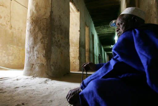 A pilgrim prays inside Timbuktu's Djingareyber Mosque in 2006. The Islamists controlling northern Mali on Tuesday destroyed two tombs at the ancient Djingareyber mosque in fabled Timbuktu, vowing to destroy all World Heritage sites in the region