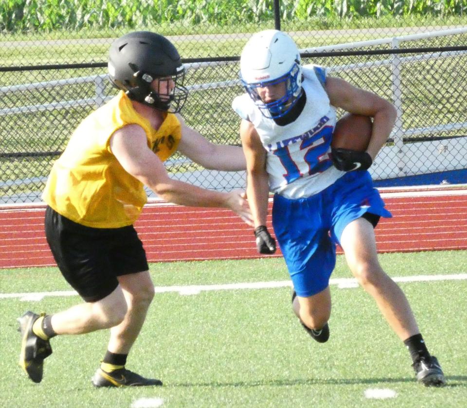 Lakewood sophomore Hunter Crawford attempts to elude a visiting Watkins Memorial defender after the catch during a passing scrimmage on Tuesday, July 19, 2022.