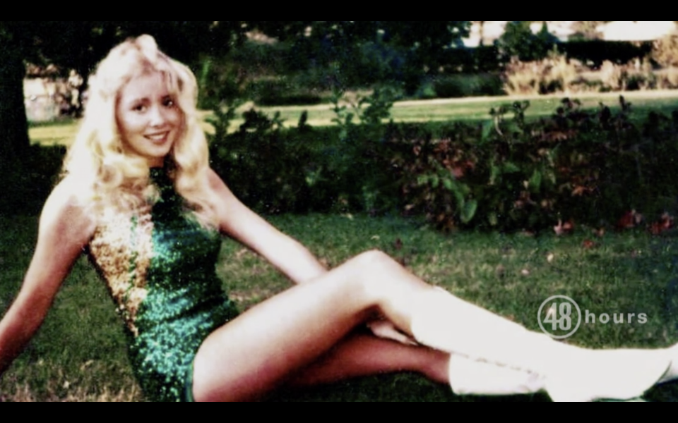 Michelle Martinko poses on the grass in a green sequin dress. 
