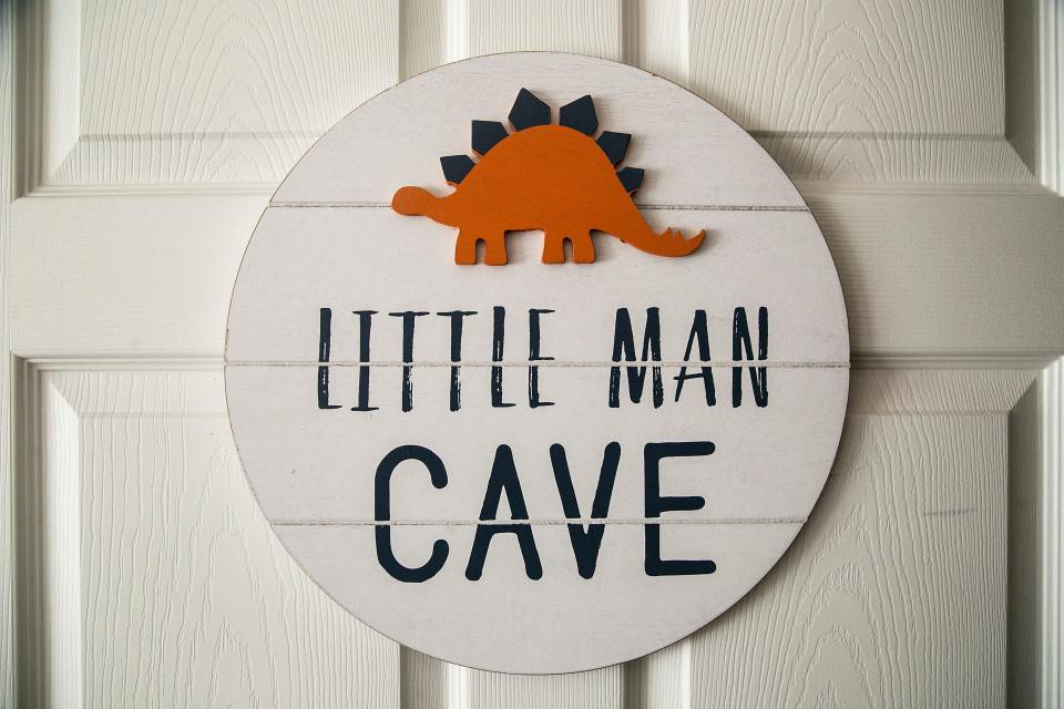 A sign with a dinosaur on it reads "Little Man Cave," Thursday, June 16, 2022, in Iowa City, Iowa.