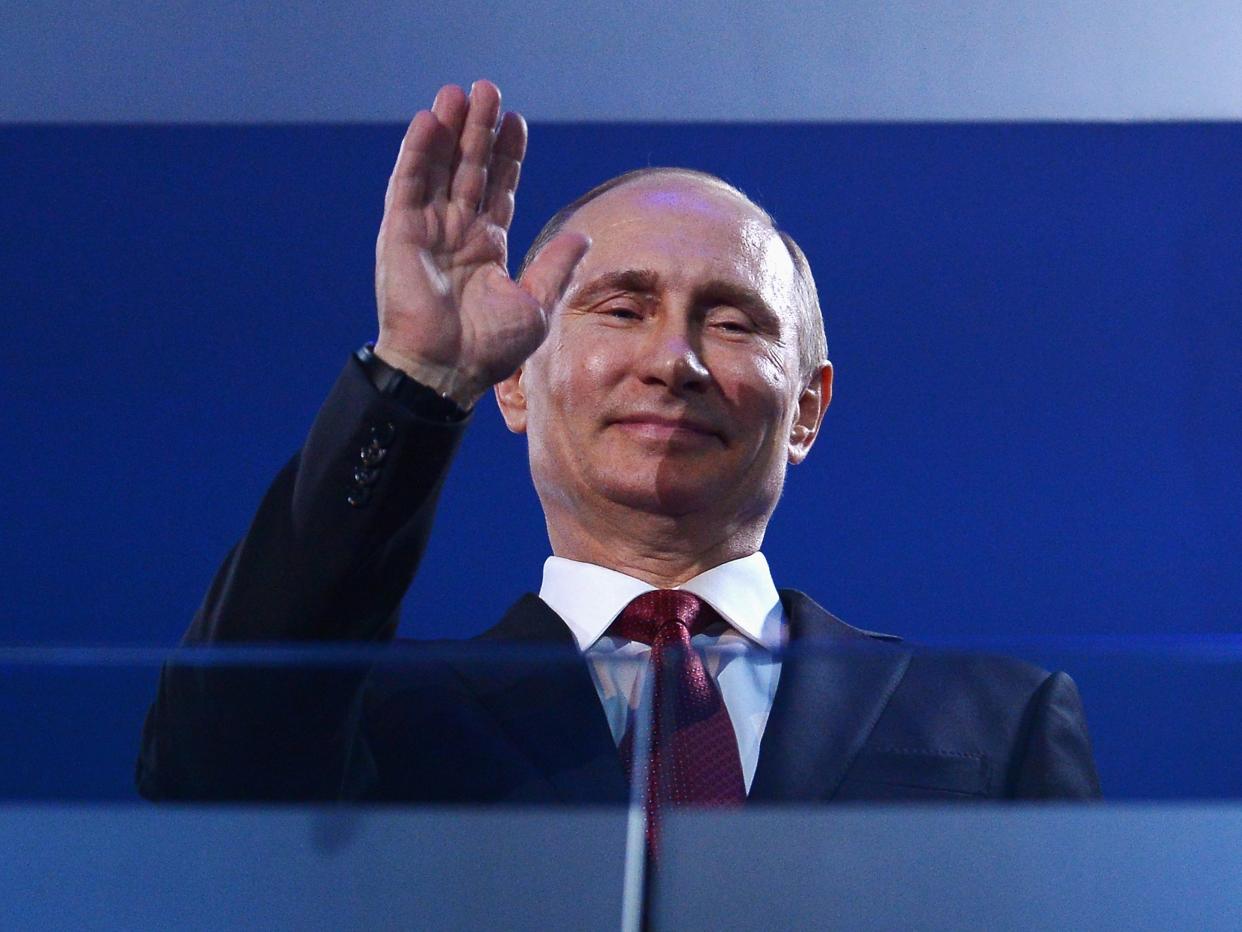 Russia President Vladimir Putin waves.