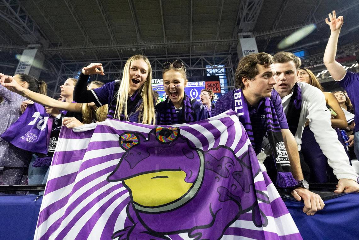 TCU fans cheer on their team while holding a hpynatoad flag at the Vrbo Fiesta Bowl at State Farm Stadium in Glendale, Ariz., on Saturday.