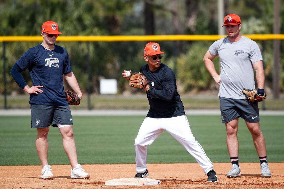 Detroit Tigers third base coach Joey Cora talks to infielders Colt Keith, right, and Jace Jung, left, during spring training at TigerTown in Lakeland, Fla. on Friday, Feb. 16, 2024.