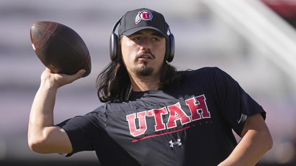 Utah quarterback Cameron Rising warms up during a game against Weber State.