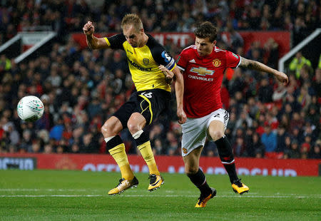 Soccer Football - Carabao Cup Third Round - Manchester United vs Burton Albion - Old Trafford, Manchester, Britain - September 20, 2017 Burton Albion's Luke Varney in action with Manchester United’s Victor Lindelof REUTERS/Andrew Yates