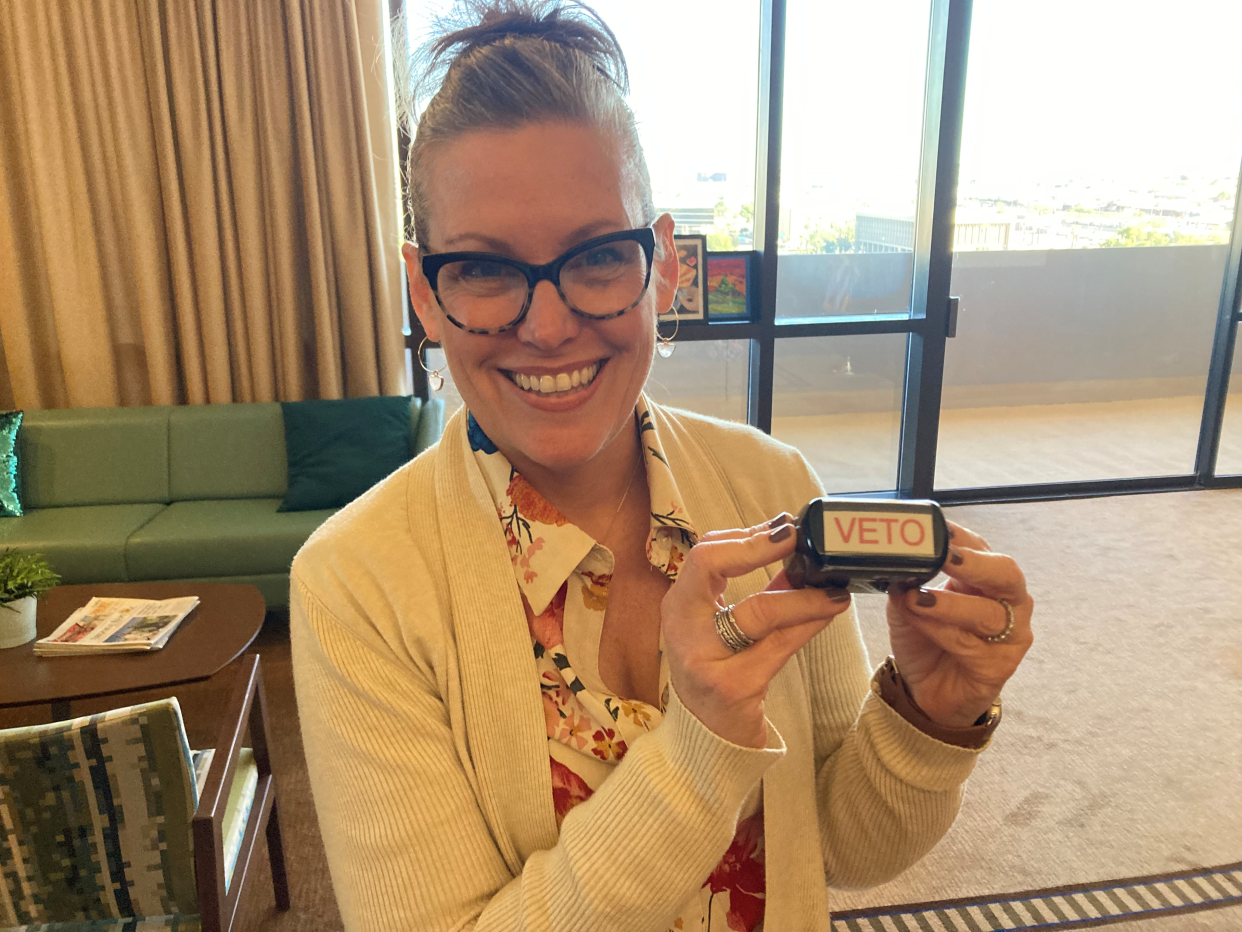 Arizona Gov. Katie Hobbs holds a veto stamp used by the state's last Democratic governor, Janet Napolitano. The stamp was a gift after Hobbs won election to the state's top office in 2022.