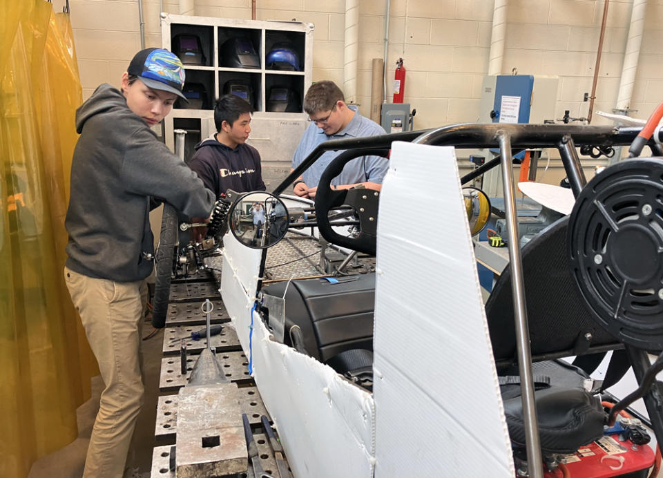 Students (l-r) Sean Murphy, Curtis Howard and Logan Harder work on an electric vehicle project they’re hoping to enter into a competition as part of a BV CAPS engineering program. (Greg Toppo)