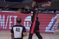 Referee Eric Lewis (42) looks on as Miami Heat's Jae Crowder (99) smiles after fouling the Boston Celtics on a shot attempt during the second half of an NBA conference final playoff basketball game, Saturday, Sept. 19, 2020, in Lake Buena Vista, Fla. (AP Photo/Mark J. Terrill)