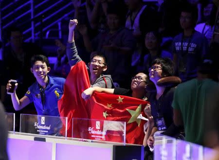 Fans holding the flag of the People's Republic of China cheer for CDEC Gaming during the Grand Finals of The International Dota 2 Championships at Key Arena in Seattle, Washington August 8, 2015. REUTERS/Jason Redmond