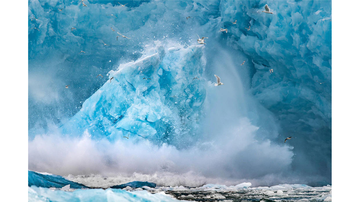  Colour photograph of an iceberg floating in the Arctic Ocean, in Svalbard, a Norwegian archipelago. 