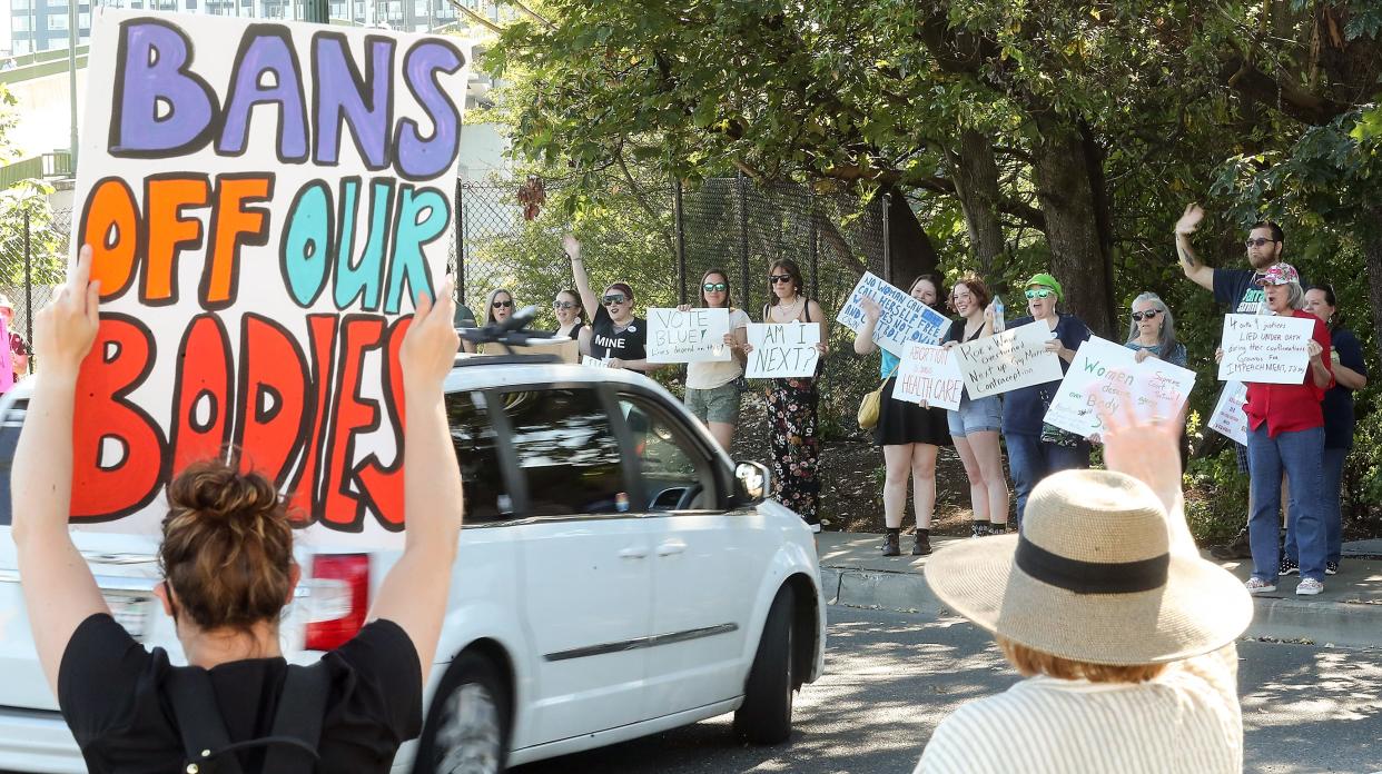 Abortion-rights advocates rally in reaction to the Supreme Court overturning Roe v. Wade at the Manette Bridge roundabout in Bremerton on Friday.