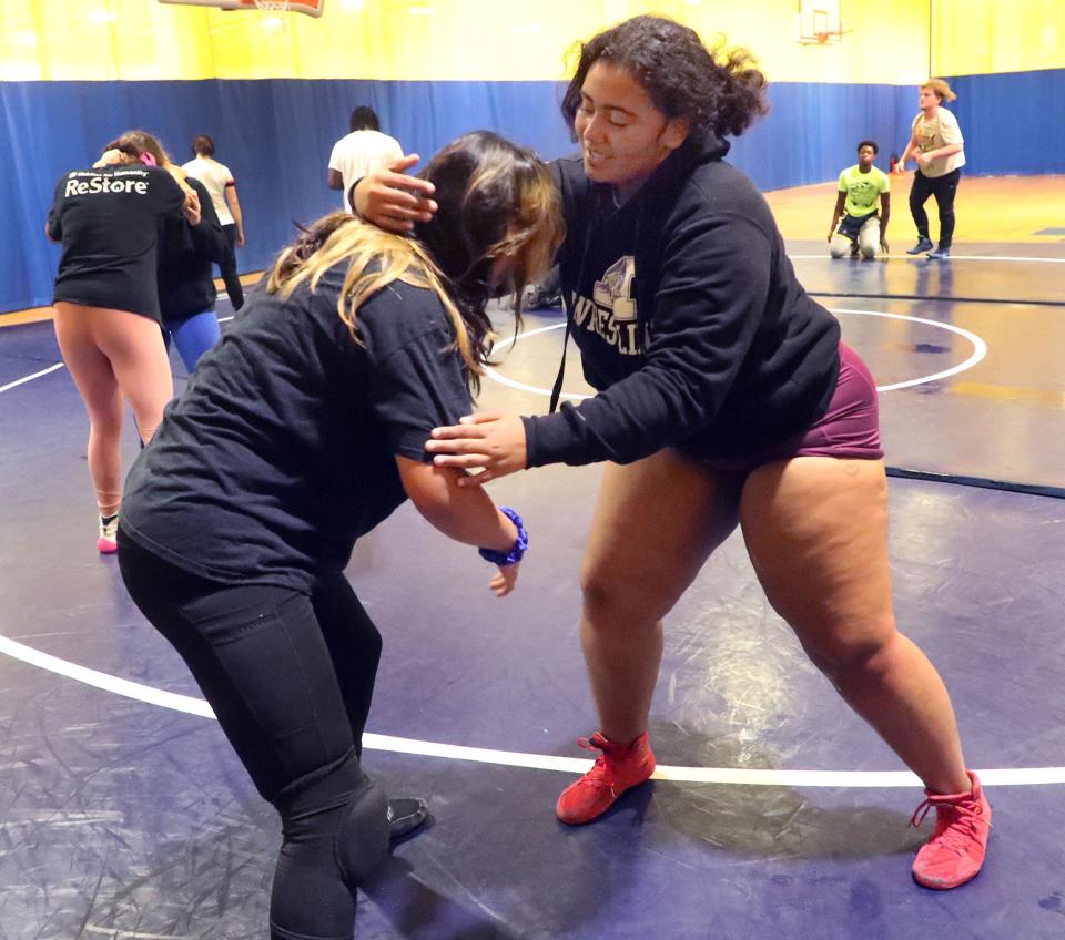 Mainland wrestler Cheyenne Wigley (right) trains with teammate Eva Rojas during practice, Tuesday, Feb. 13, 2024, at Mainland High School.