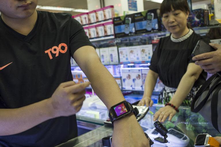 A man shows off a Chinese-made copy of the Apple Watch in Huaqiangbei Commercial Street in the southern Chinese city of Shenzhen, April 24, 2015