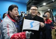 Ice Hockey – Pyeongchang 2018 Winter Olympics – Women Preliminary Round Match - Korea v Japan - Kwandong Hockey Centre, Gangneung, South Korea – February 14, 2018 - Kim Jong-un impersonator holds a Korean unification flag. REUTERS/Lucy Nicholson